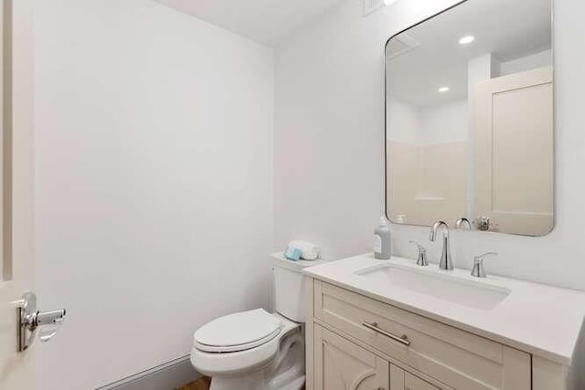 bathroom with toilet and vanity