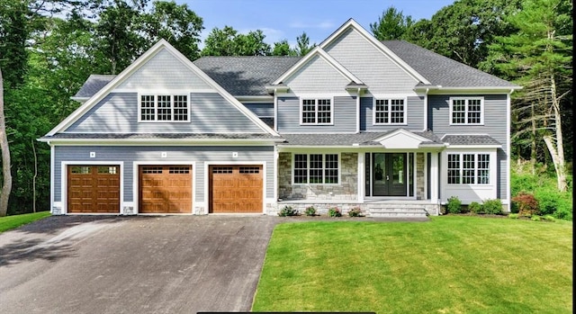 craftsman-style house featuring a front lawn and a garage