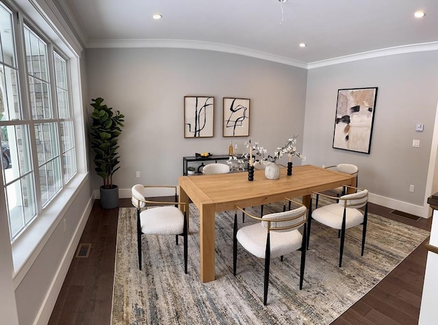 dining room with ornamental molding, dark hardwood / wood-style floors, and plenty of natural light