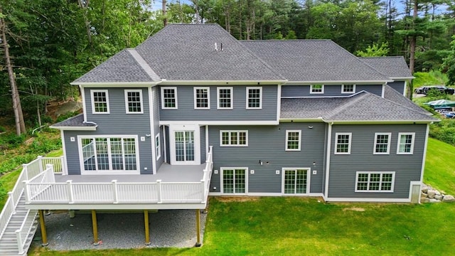 back of house featuring a yard and a wooden deck