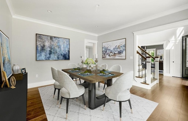 dining room with ornamental molding and hardwood / wood-style floors