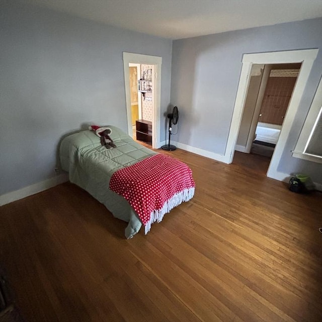 bedroom with hardwood / wood-style flooring