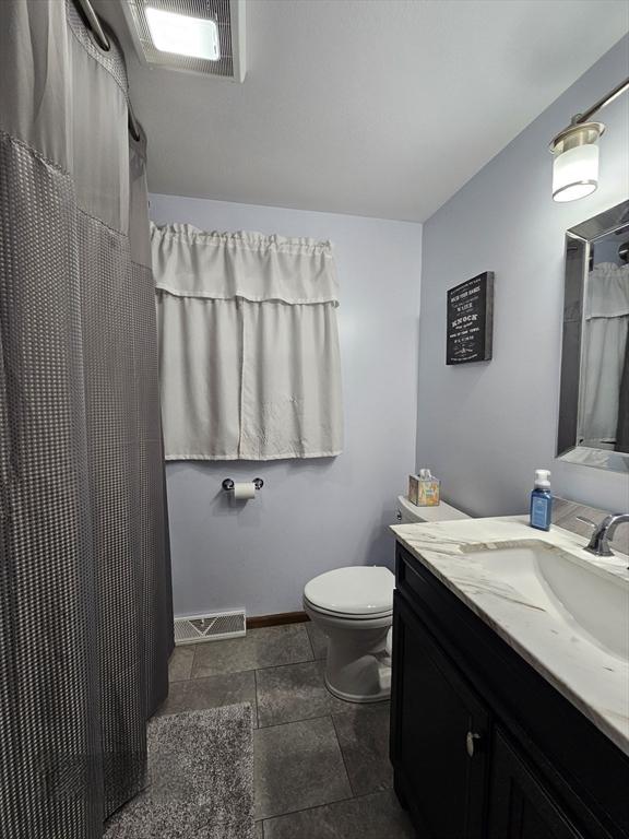 bathroom with vanity and toilet