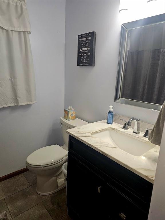 bathroom with vanity, tile patterned flooring, and toilet