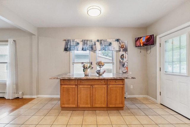 63 Beverly St, Chicopee, MA 01013 - kitchen with healthy amount of natural light, a baseboard heating unit, and light tile patterned floors