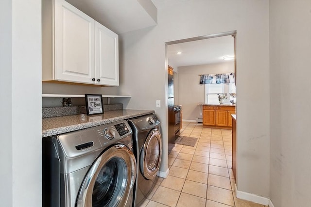 63 Beverly St, Chicopee, MA 01013 - laundry area featuring cabinet space, independent washer and dryer, baseboards, light tile patterned flooring, and baseboard heating