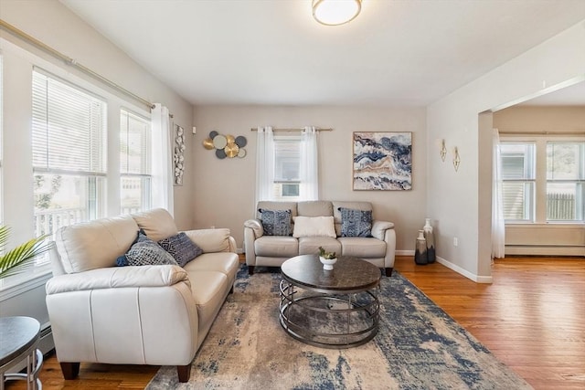 63 Beverly St, Chicopee, MA 01013 - living room with baseboard heating, healthy amount of natural light, wood finished floors, and baseboards