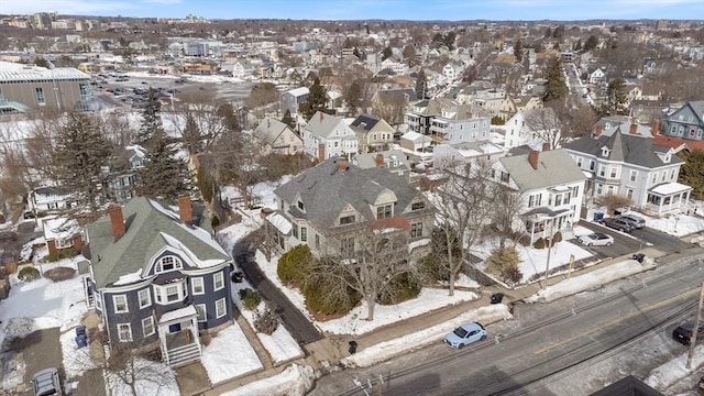 snowy aerial view featuring a residential view