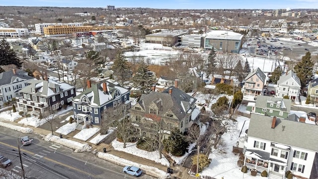 snowy aerial view with a residential view