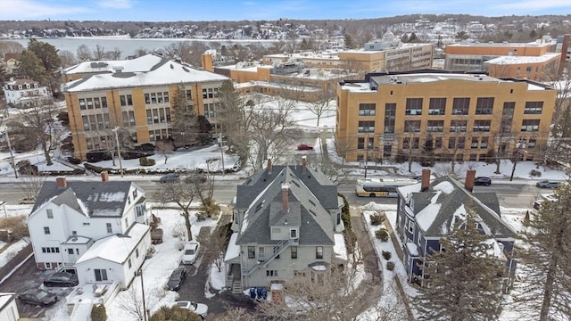 snowy aerial view with a residential view