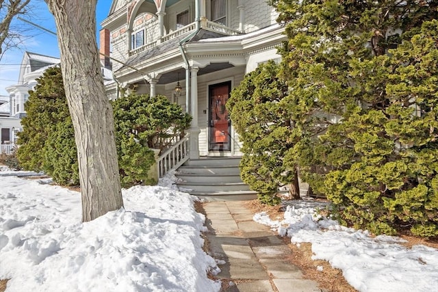 view of snow covered property entrance