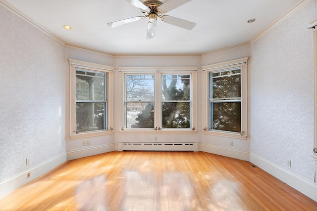 unfurnished room with baseboards, light wood finished floors, a baseboard radiator, and crown molding