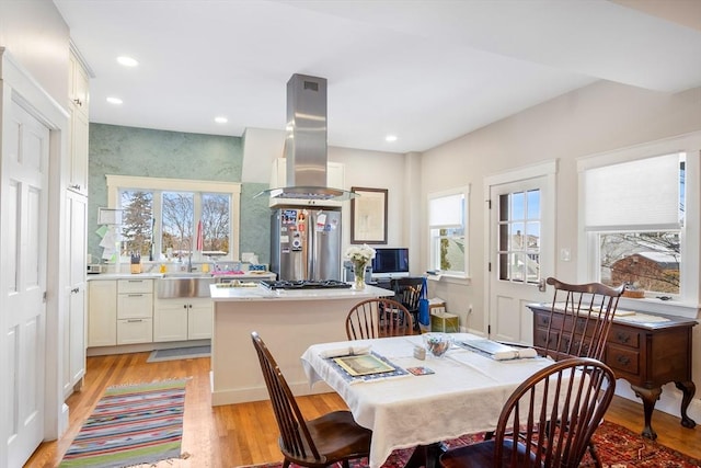 dining space with recessed lighting, plenty of natural light, and light wood-style floors