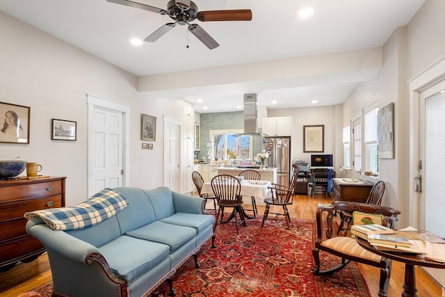 living room with a ceiling fan, wood finished floors, and recessed lighting