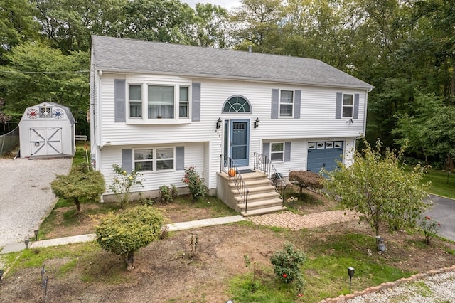 bi-level home with a garage and a shed