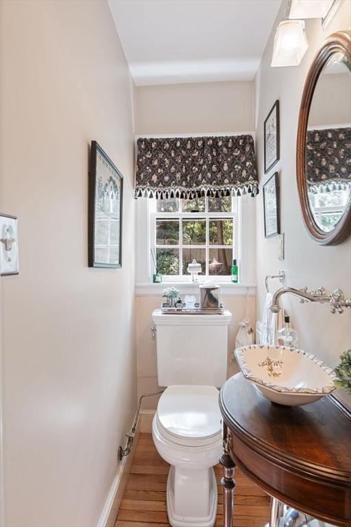 bathroom with sink, hardwood / wood-style flooring, and toilet