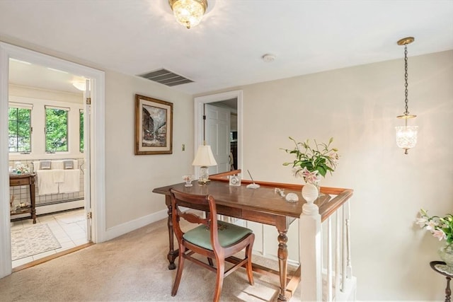 carpeted dining space with a baseboard heating unit