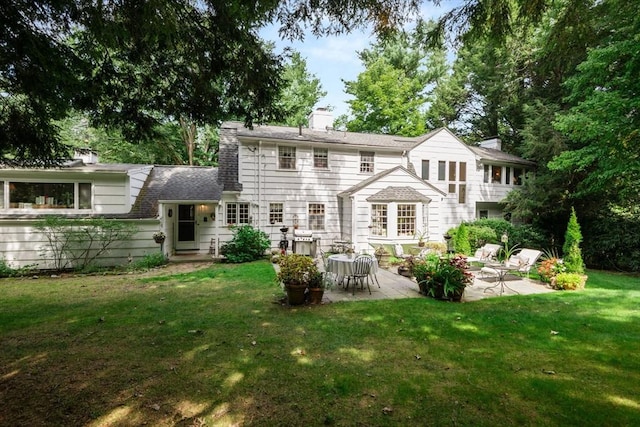 rear view of property with a patio area and a yard