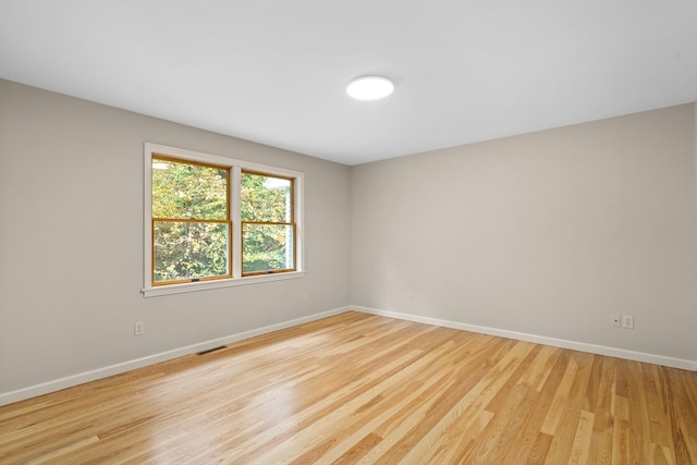 spare room featuring light wood-type flooring