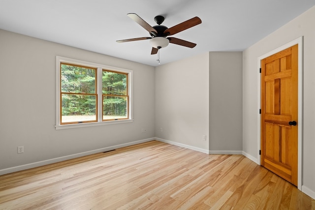 spare room with ceiling fan and light wood-type flooring