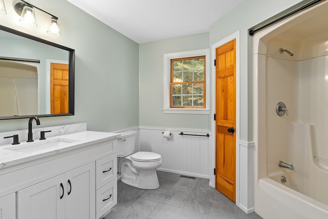 full bathroom featuring washtub / shower combination, vanity, and toilet