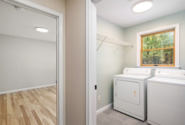 laundry area featuring light hardwood / wood-style floors and washer and clothes dryer