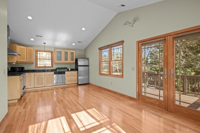 kitchen with light brown cabinetry, sink, decorative light fixtures, light hardwood / wood-style flooring, and appliances with stainless steel finishes