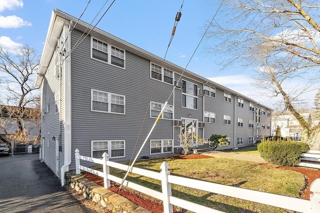 view of property exterior featuring a lawn