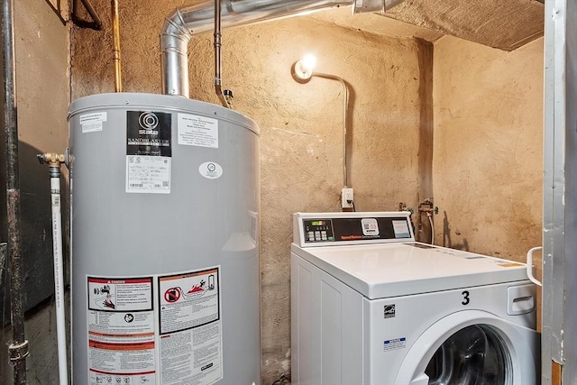 clothes washing area with gas water heater and washer / dryer