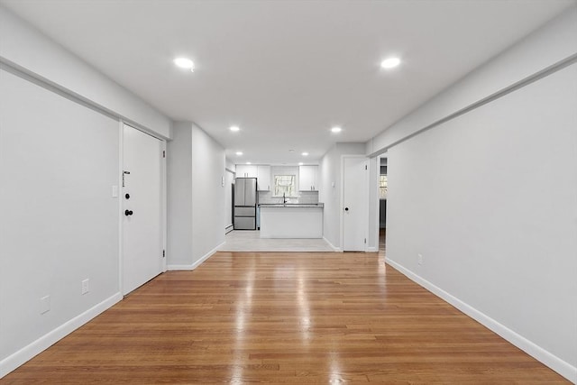 interior space featuring sink and light wood-type flooring