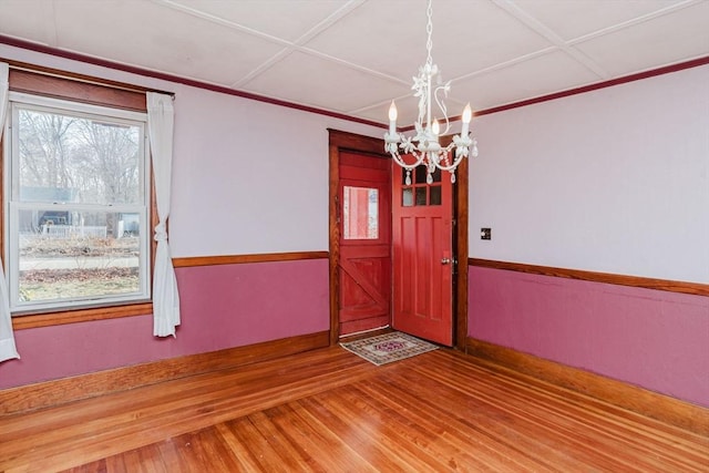 foyer entrance with wood-type flooring and a notable chandelier