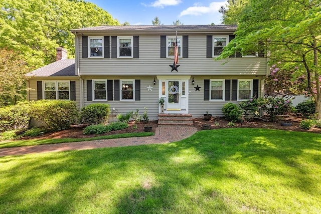 23 Fletcher St, Foxboro, MA 02035 - colonial home with a front lawn and a chimney