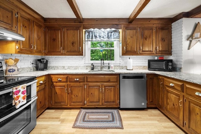 23 Fletcher St, Foxboro, MA 02035 - kitchen featuring appliances with stainless steel finishes, a sink, under cabinet range hood, beamed ceiling, and light wood-style flooring