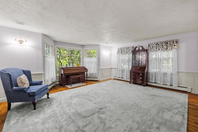 23 Fletcher St, Foxboro, MA 02035 - sitting room featuring a wainscoted wall, a decorative wall, baseboard heating, and wood finished floors