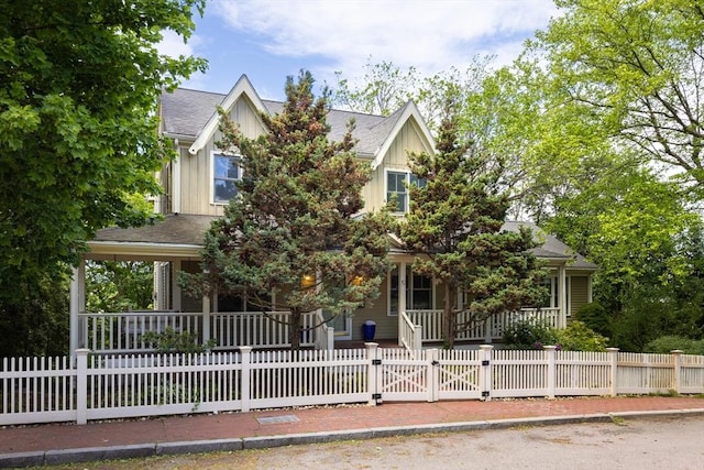 17-19 Beech Gln, Boston, MA 02119 - obstructed view of property featuring covered porch, a fenced front yard, board and batten siding, a gate, and roof with shingles