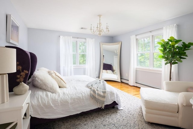 17-19 Beech Gln, Boston, MA 02119 - bedroom with multiple windows, a chandelier, wood finished floors, and a baseboard heating unit