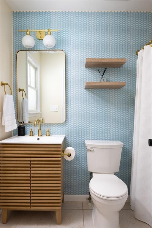 17-19 Beech Gln, Boston, MA 02119 - bathroom with toilet, vanity, tile patterned floors, and baseboards