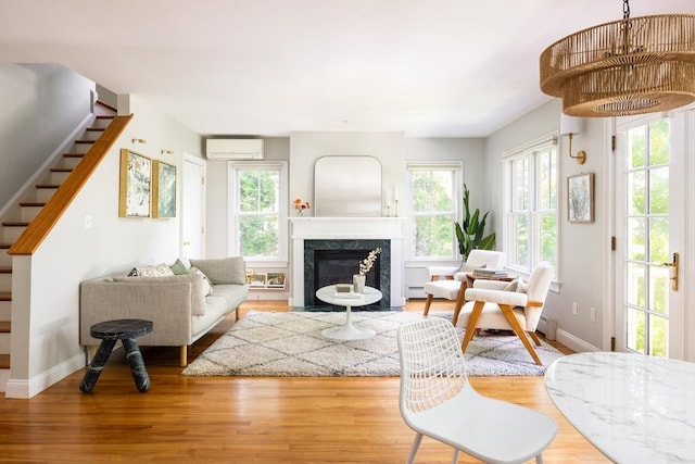 17-19 Beech Gln, Boston, MA 02119 - living area featuring a wall mounted AC, stairway, wood finished floors, and baseboards