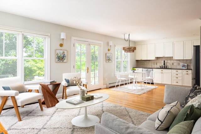 17-19 Beech Gln, Boston, MA 02119 - living room with a baseboard radiator, light wood-style flooring, and baseboards