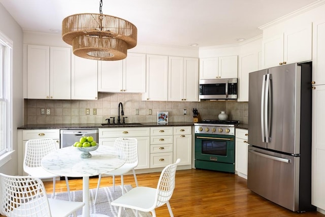 17-19 Beech Gln, Boston, MA 02119 - kitchen featuring appliances with stainless steel finishes, a sink, backsplash, wood finished floors, and crown molding
