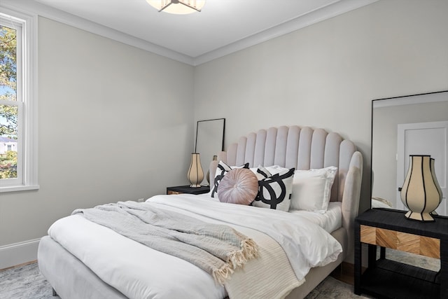 bedroom featuring multiple windows and crown molding