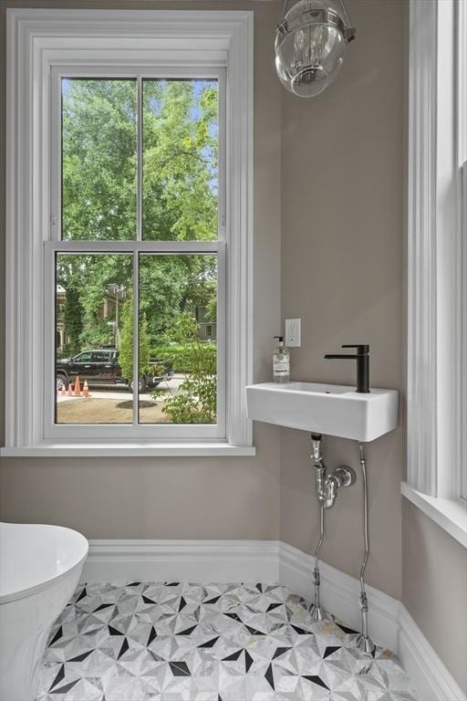 17 Alveston St, Boston, MA 02130 - half bathroom with a chandelier, baseboards, a sink, and toilet