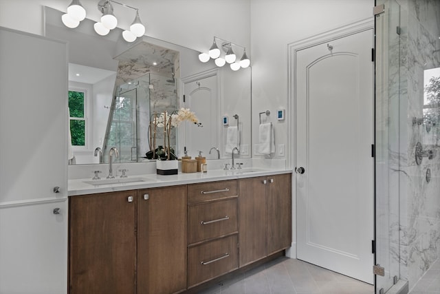 bathroom with a shower with door, tile patterned floors, and vanity