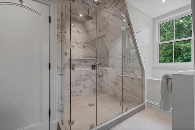 bathroom with a shower with shower door and tile patterned flooring