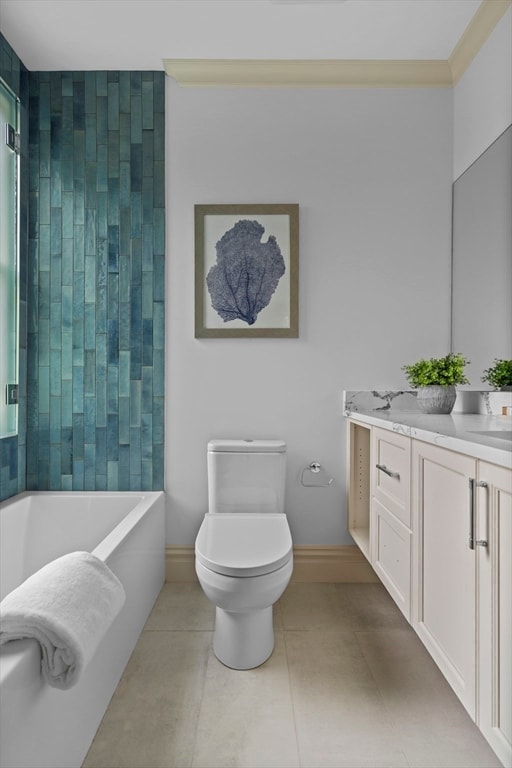 bathroom featuring a bathing tub, toilet, tile patterned flooring, and vanity