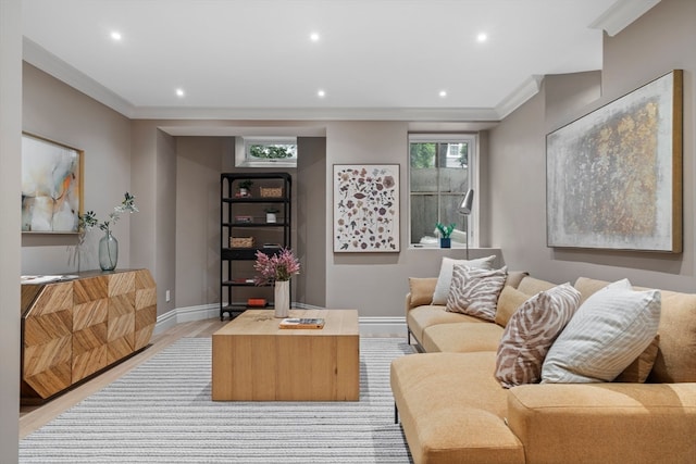 living room featuring light hardwood / wood-style flooring and crown molding