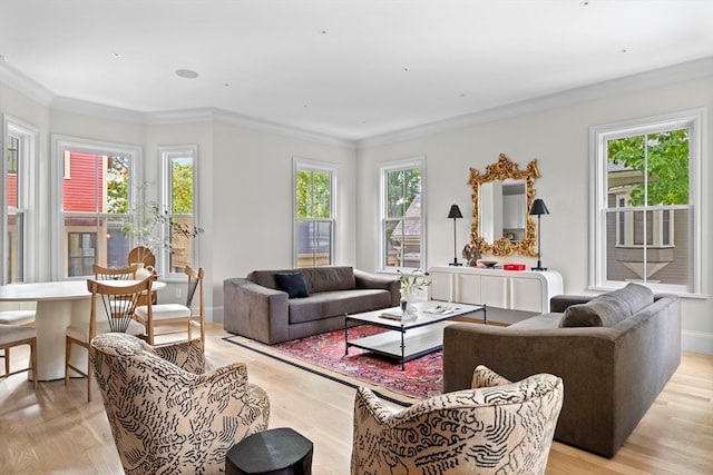 living room featuring light wood-type flooring, ornamental molding, and a wealth of natural light