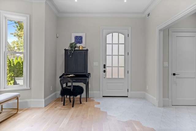 entryway with ornamental molding and light wood-type flooring