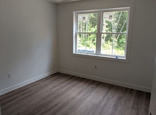 spare room featuring dark hardwood / wood-style floors