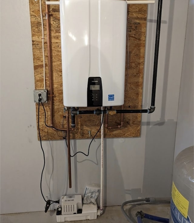 utility room featuring tankless water heater